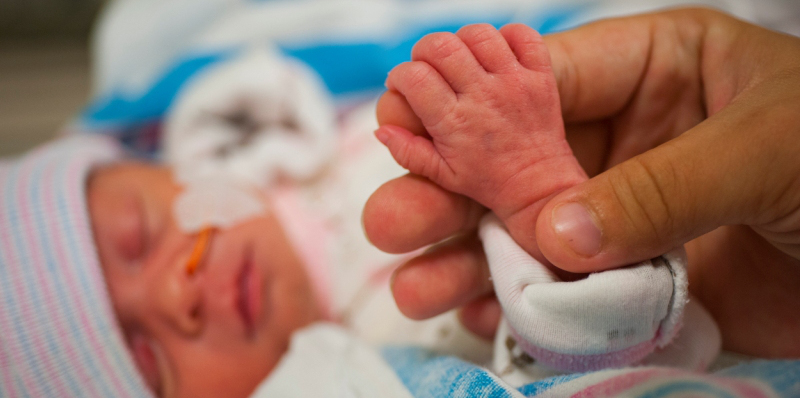 holding hand of a new born child