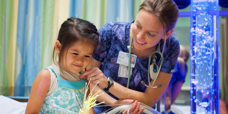 A nurse helping a girl patient