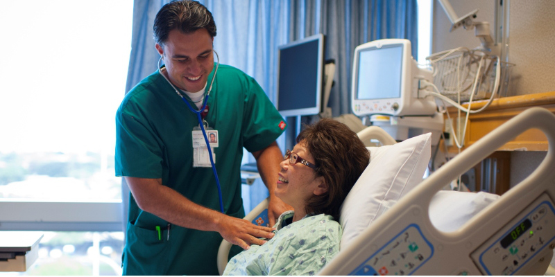 patient getting her heart checked in the hospital bed
