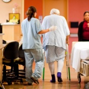 medical professional helping elderly patient