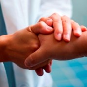 a close up of someone holding another person's hand