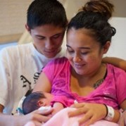 young parents holding newborn