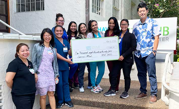 group shot with giant check