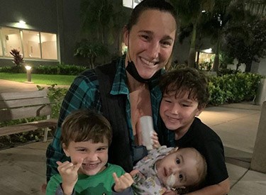 Akamu with his mom, Christie, and two of his three older brothers.