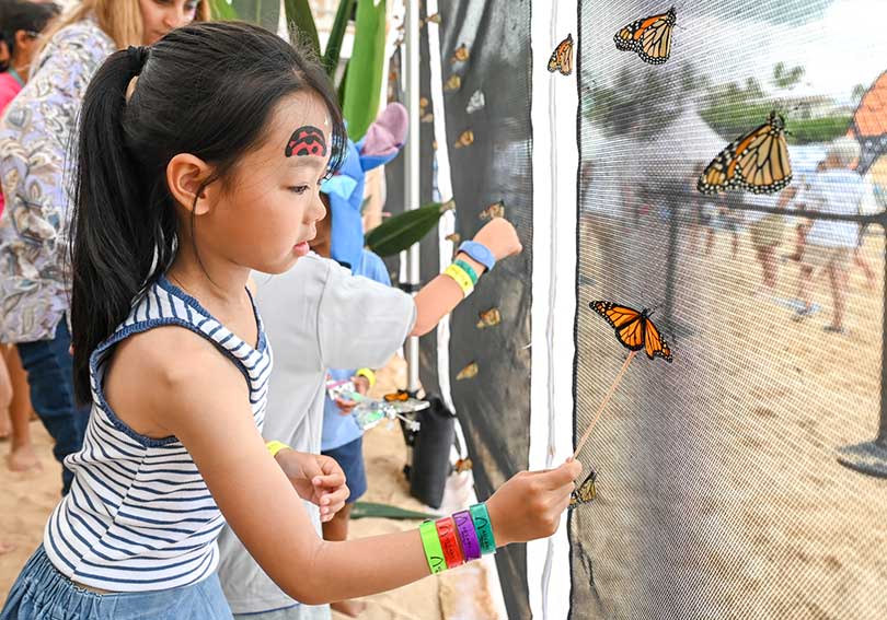 Girl with monarch butterflies.