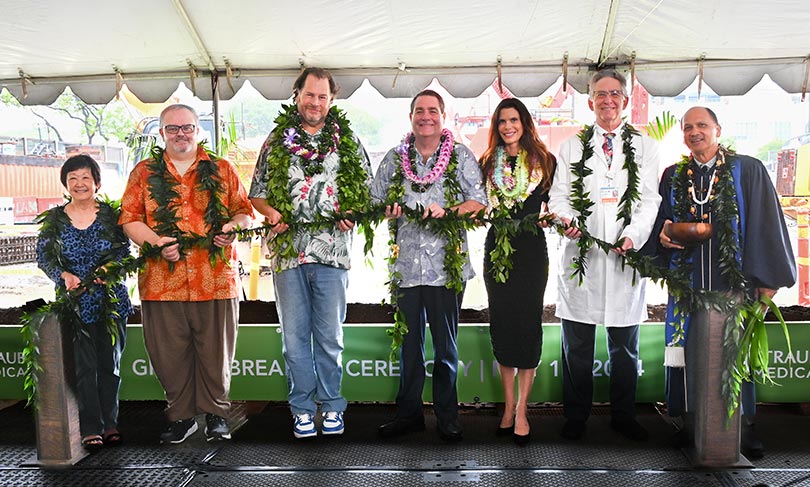 Group holding maile lei as part of a groundbreaking ceremony.