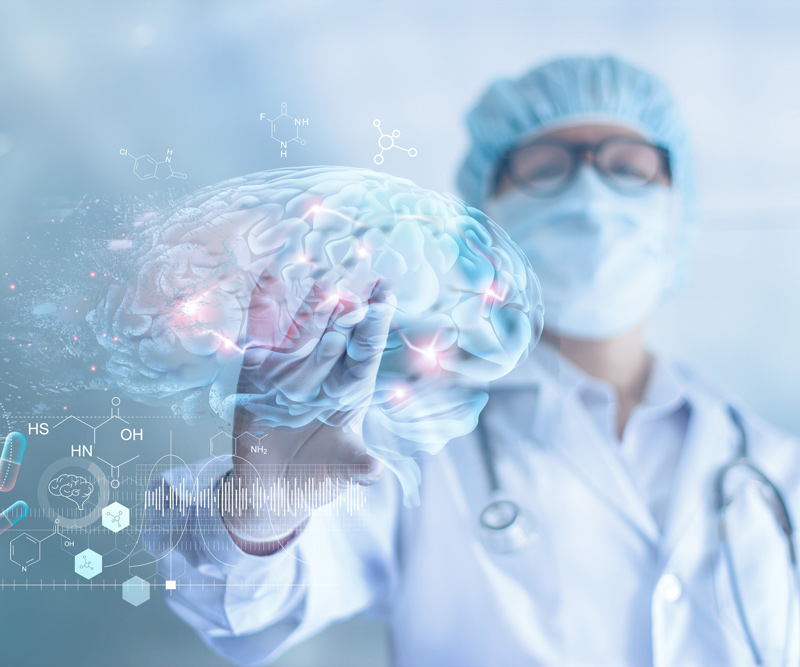 a doctor dressed in scrubs looks at a digital image of a brain with hot spots where neurons are firing