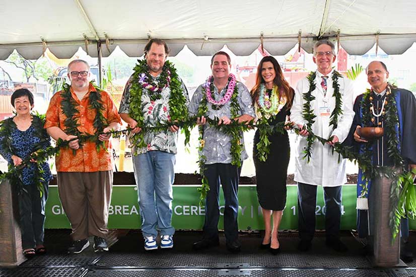 Group holding maile lei as part of a groundbreaking ceremony.