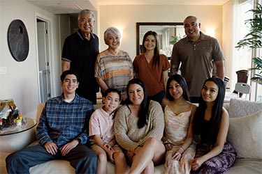 Group shot of smiling family in their home.