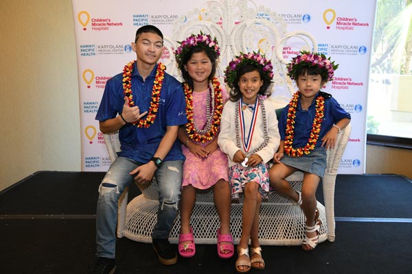 Aurelia Awa with three previous Hawaii CMN Champions.