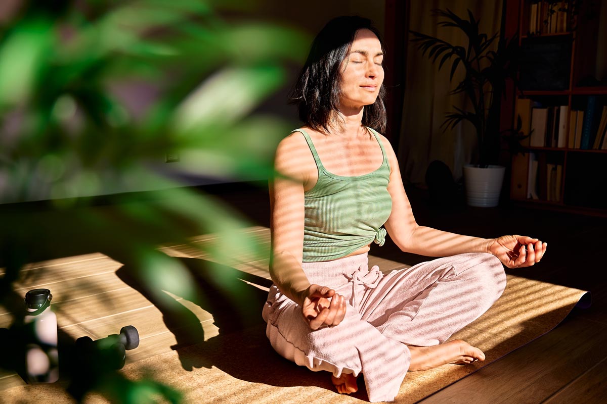 a young woman practices meditative breathing exercises