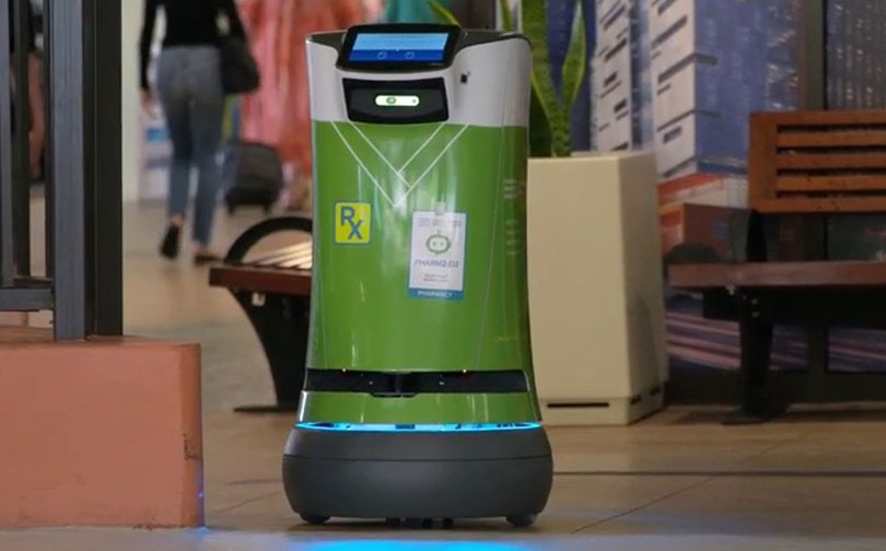 Small green cylindrical robot used for secure pharmacy deliveries.
