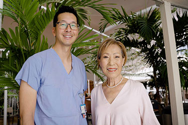 Chung Lucky stands with Dr. Jeremy Lum at Straub Benioff Medical Center.