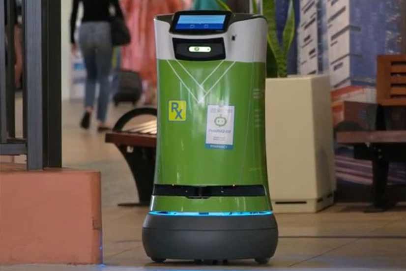 Small green cylindrical robot used for secure pharmacy deliveries.