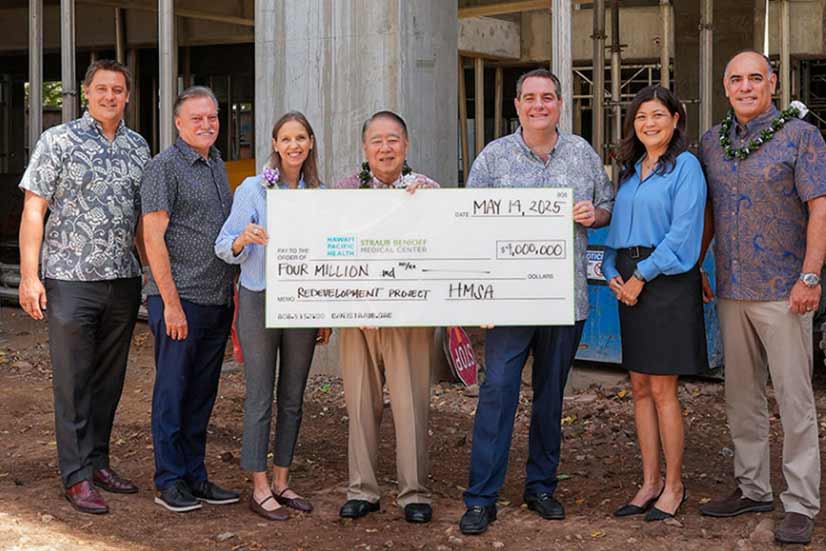 Group shot of HMSA and Straub Benioff executives at a $4 million check presentation.