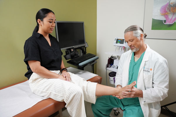 Dr. Daniel Judd examines a patient's ankle to make sure everything is in proper working order.