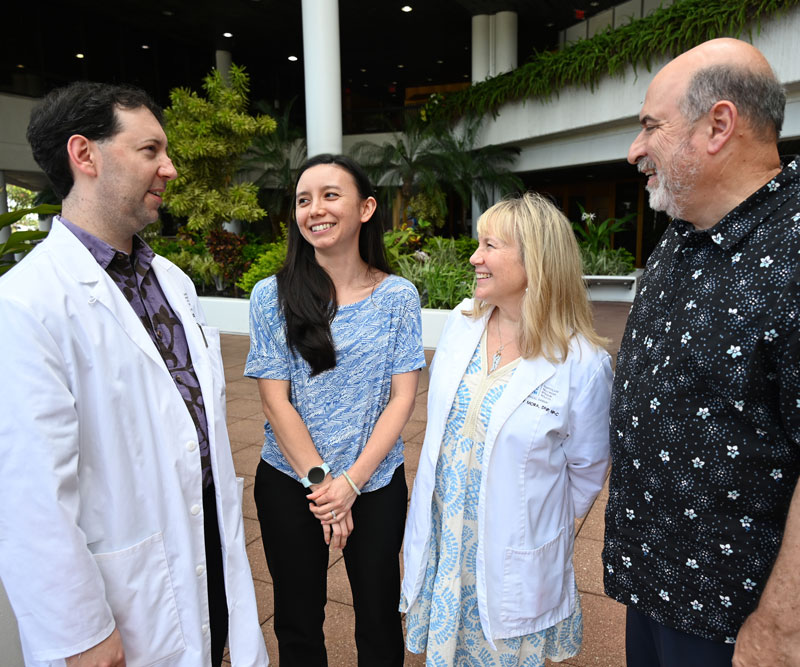 a group of four people talking