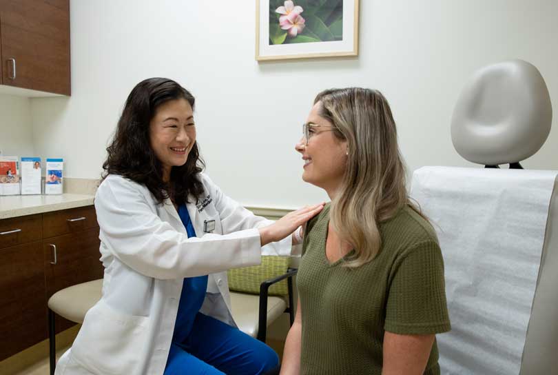 Doctor examining patient in exam room.
