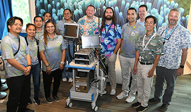 Group shot of fundraisers with ECMO machine.