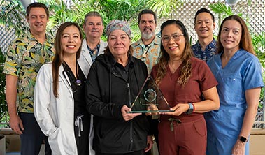 Group shot of health care providers and administrators holding an award.