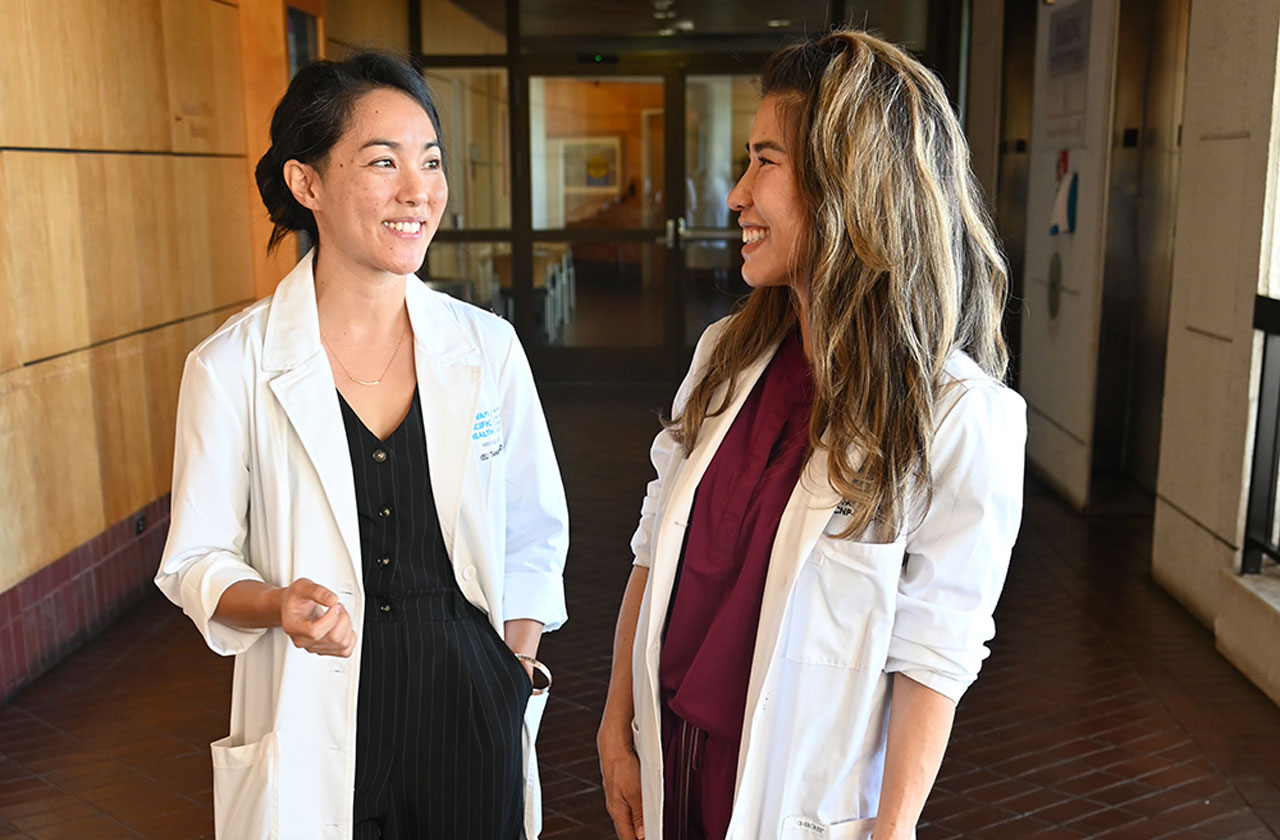 Dr. Keli Tahara talks with Fay Stearns, Pali Momi neurology nurse practitioner.