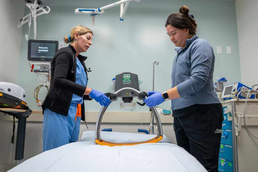 Straub Benioff Emergency Department nurses Amanda Hines and Lisa Fillipone set up a LUCAS chest compression machine.