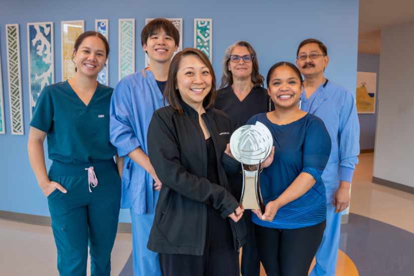 Representatives from across Hawaii Pacific Health pose with the 2026 Gallup Great Workplace Award trophy.