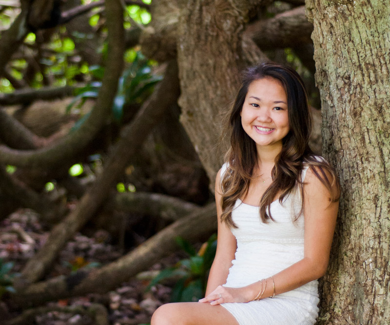 Tiare Tia Fuchigami sitting next to tree