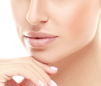 Lower face of a women touching her chin with her right hand